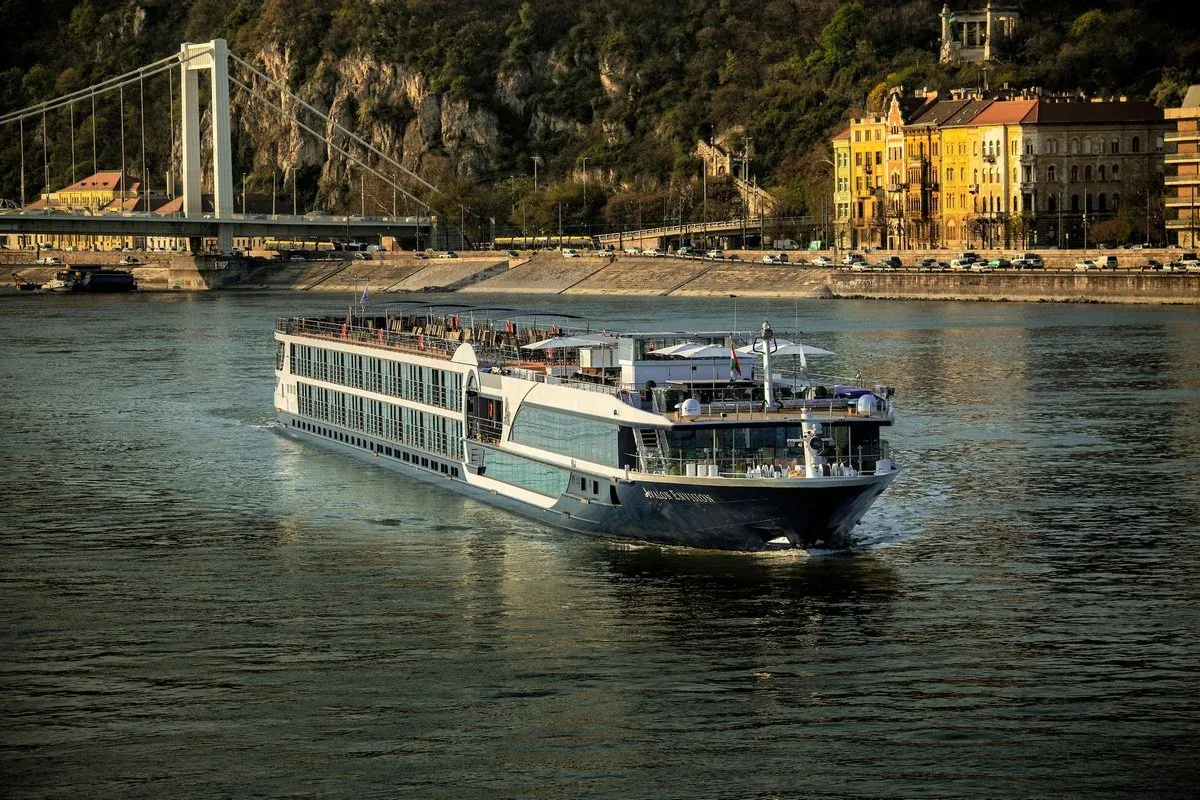 Avalon Waterways cruise ship sailing on a river next to an european city