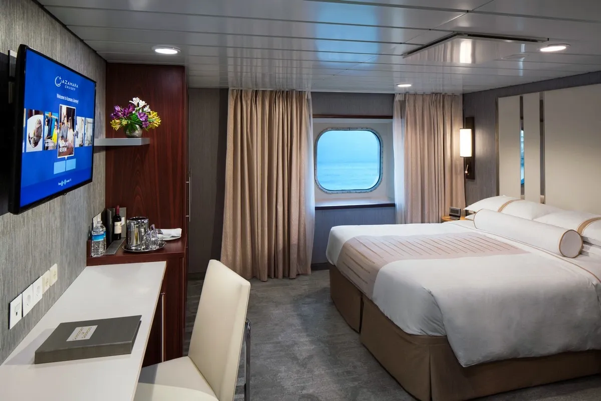 Oceanview stateroom with a queen bed and a desk