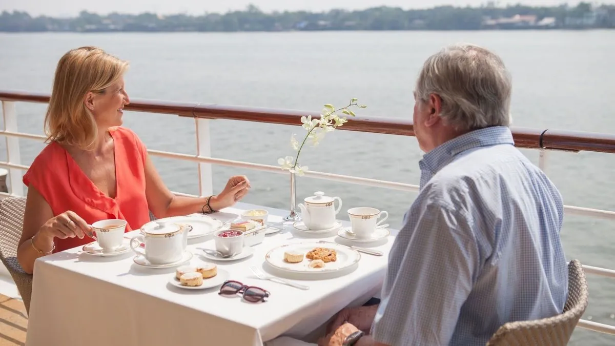 A couple having breakfast at a balcony on a cruise ship