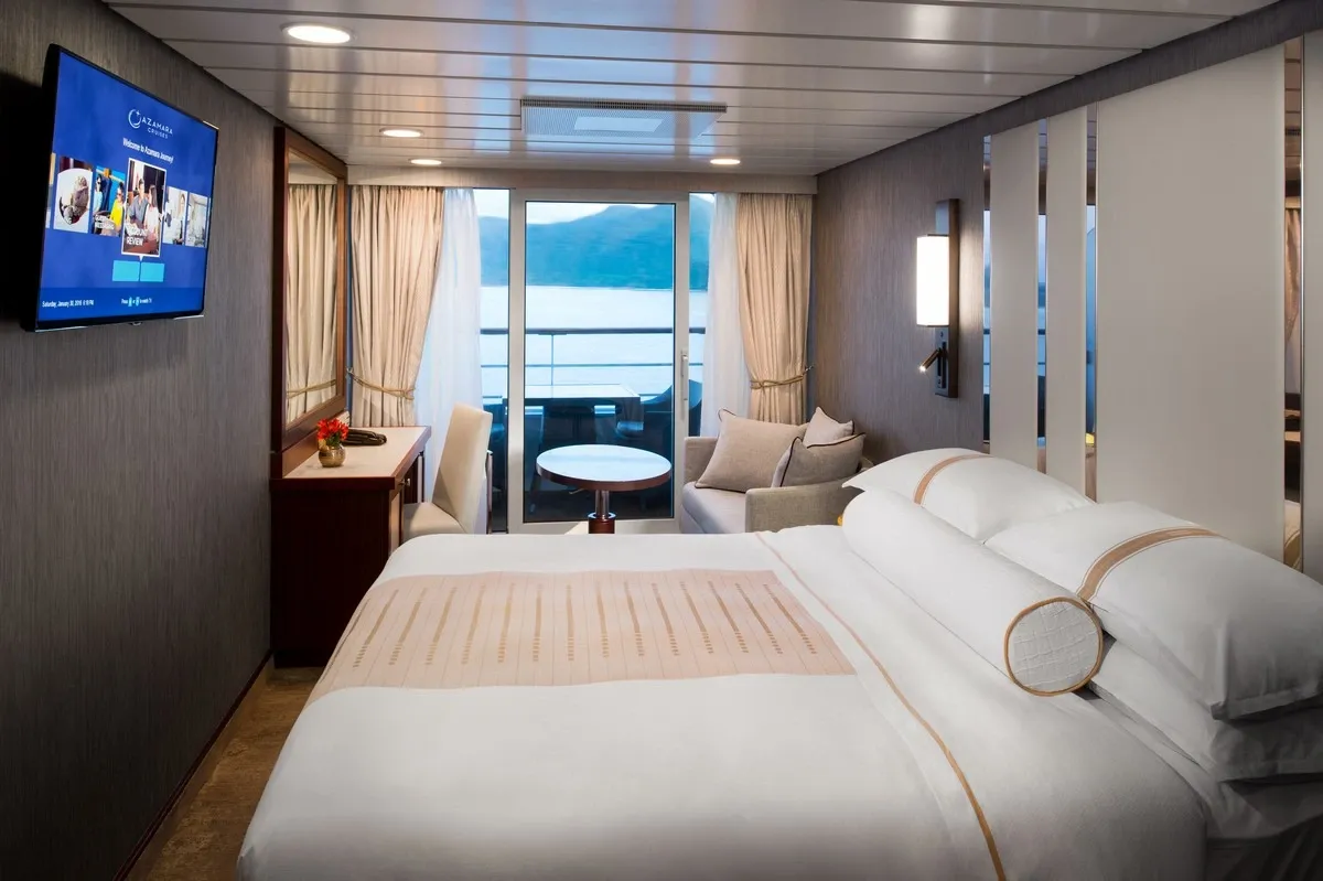 Veranda stateroom with a queen bed and a view to the river