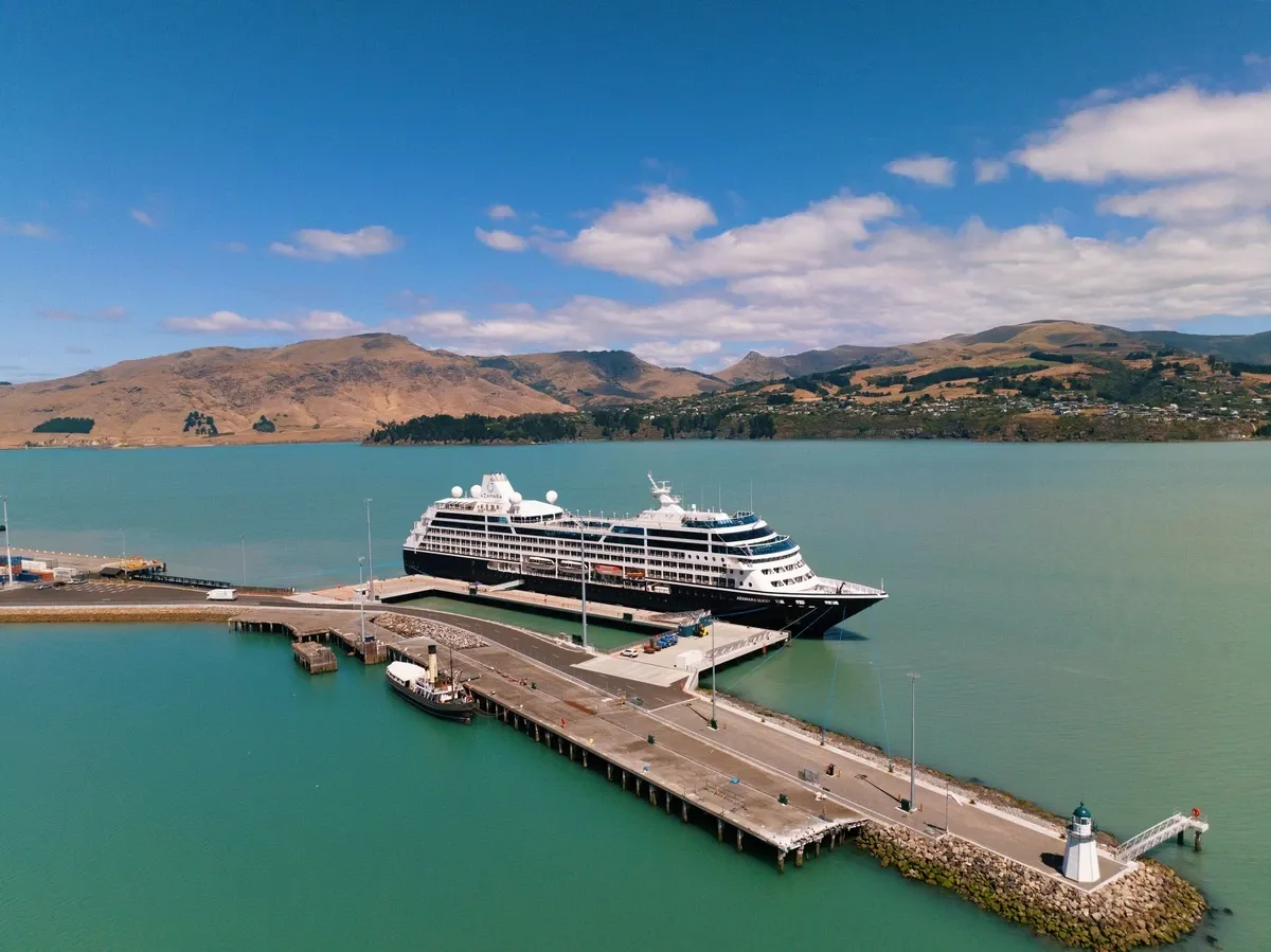 Aerial view of a cruise ship on port surrounded by a river