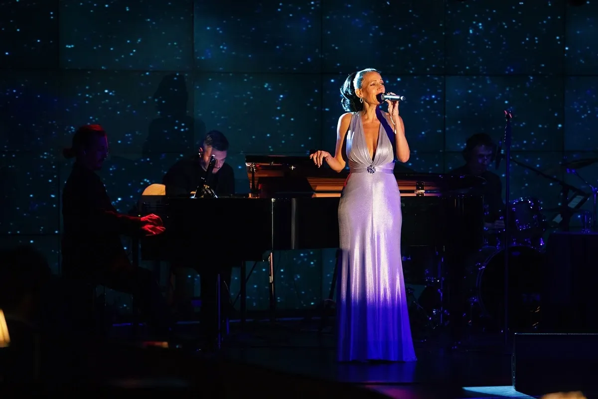 Woman on a stage singing 
