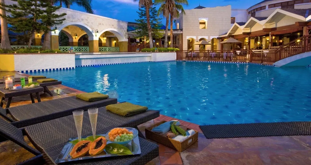 Poolside sunbeds at a resort at night