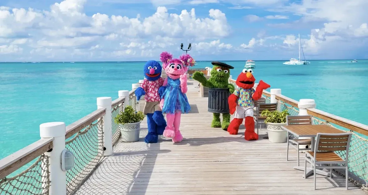 Sesame Street characters on a pier with the ocean in the background
