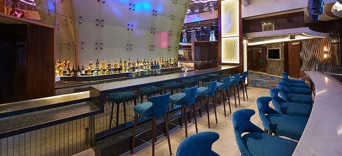 Cruise inside ship bar with two rows of blue chairs