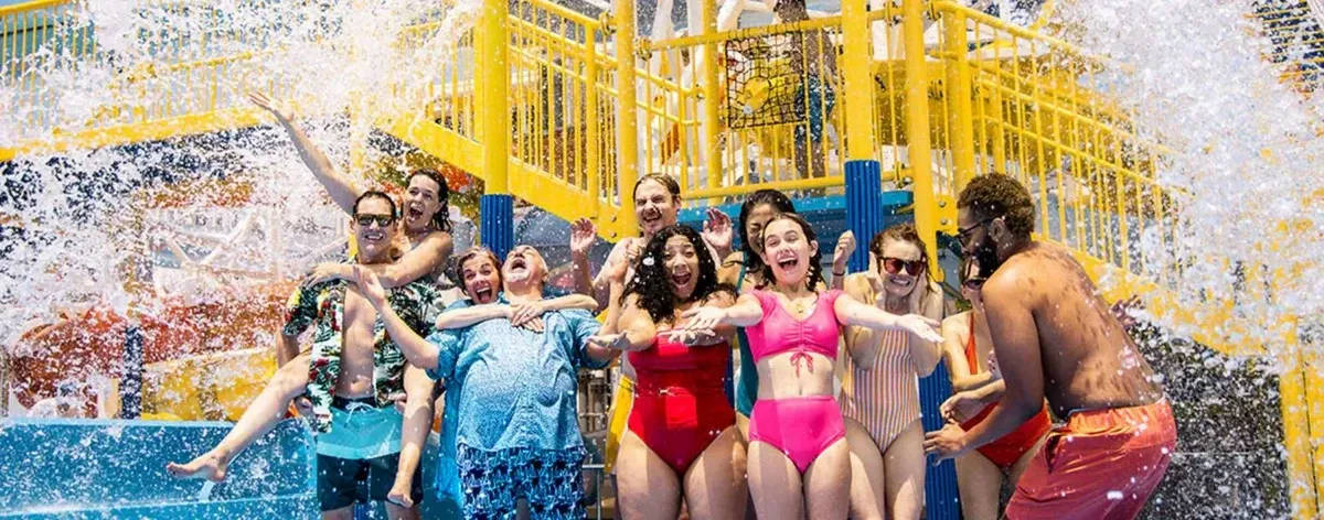 Group of people enjoying the waterpark, smiling and posing for the picture