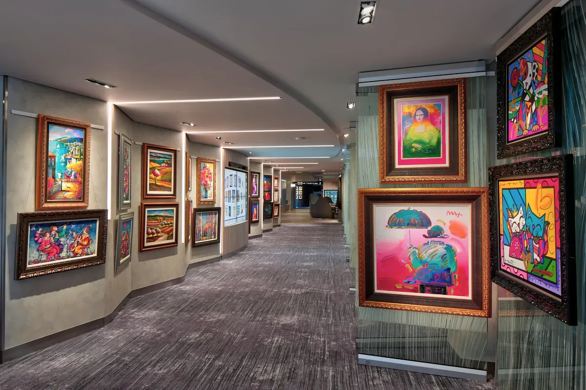Art gallery with many paintings hanging on the wall