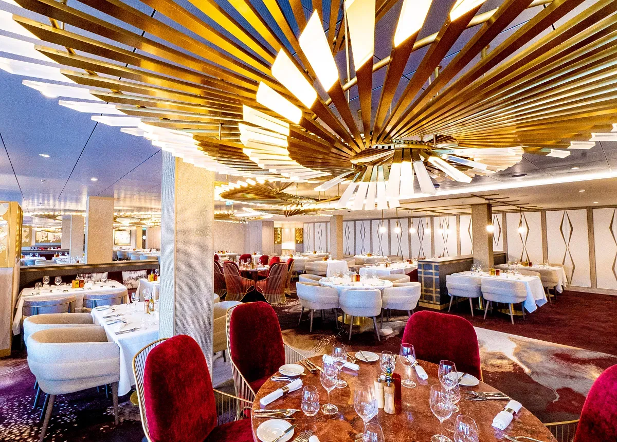 Panoramic view of a restaurant with an art lighting piece on the ceiling