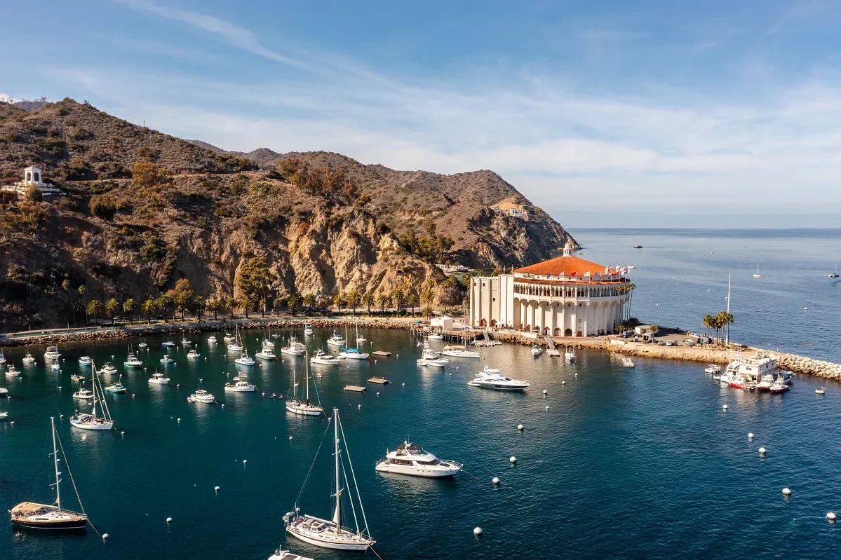 Aerial view of a mediterranean coastline with many yachts and sailboats