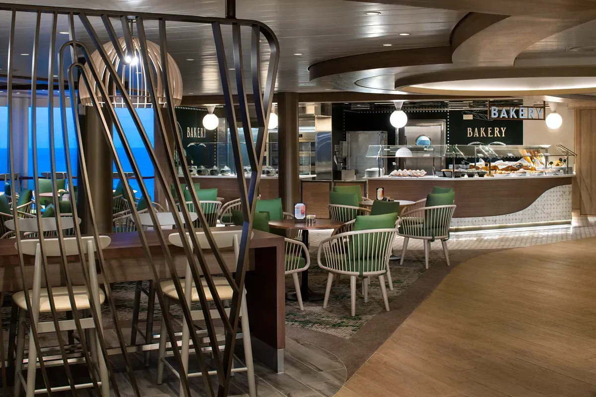 Bakery shop showcasing treats and many tables to sit at