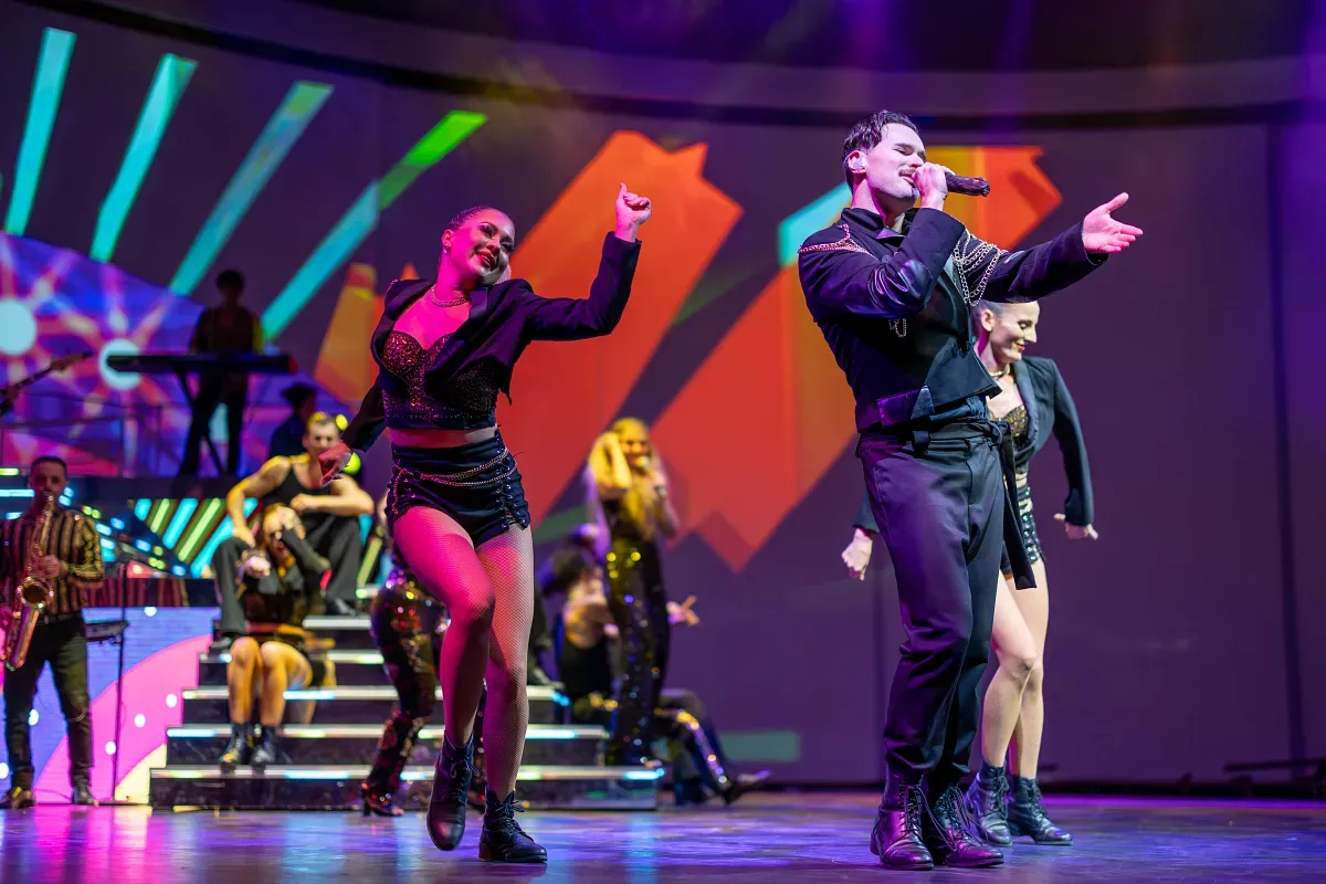 Artists singing and dancing at a night show