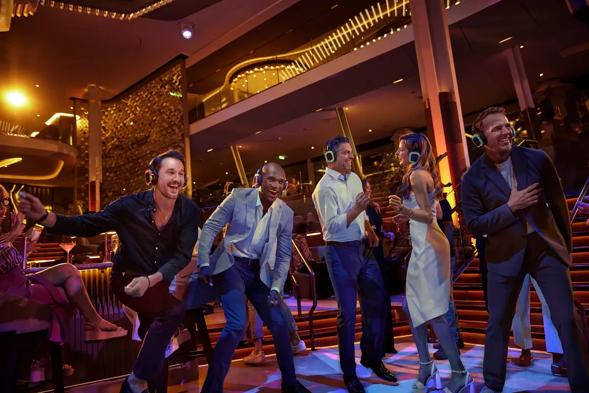 Group of people dancing and smiling at a nightclub