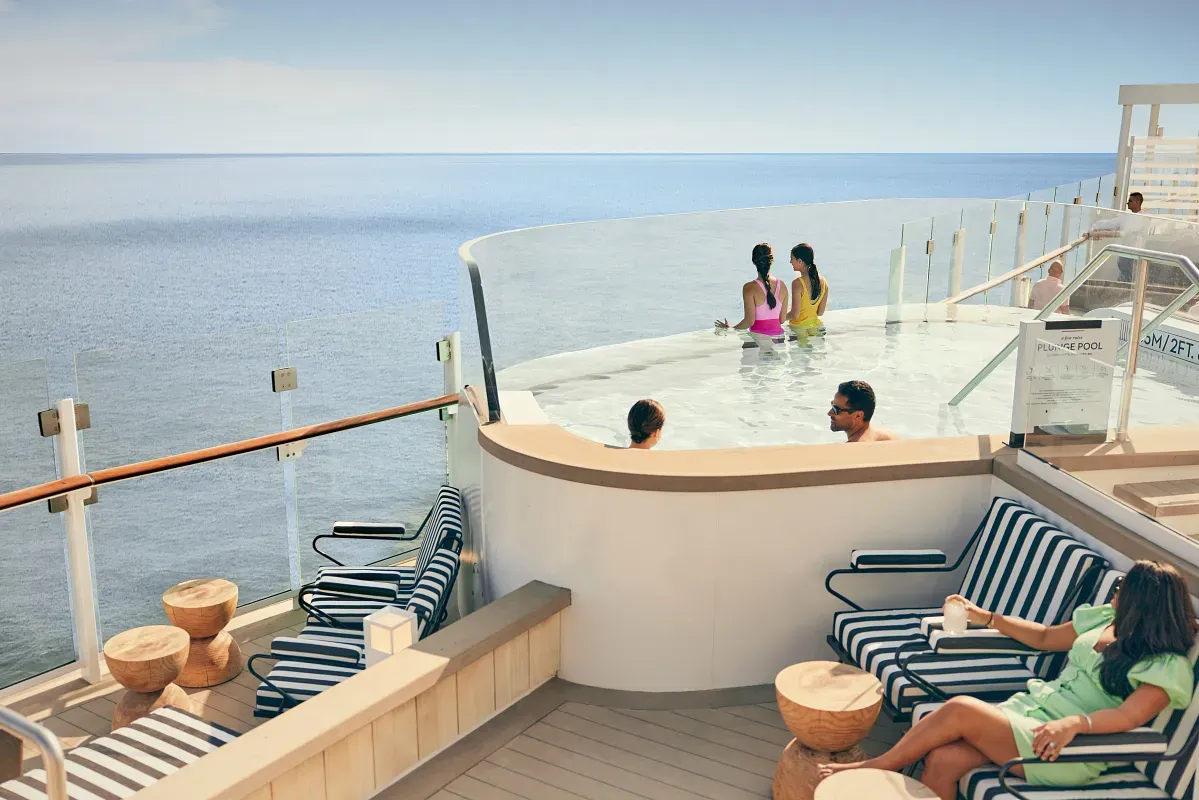 People hanging out on a jacuzzi with views to the ocean