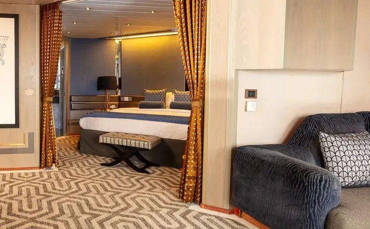 Suite view with living space and a large bed on the background