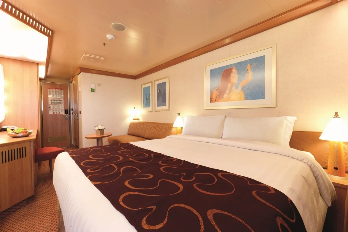 Cruise ship suite with a king bed