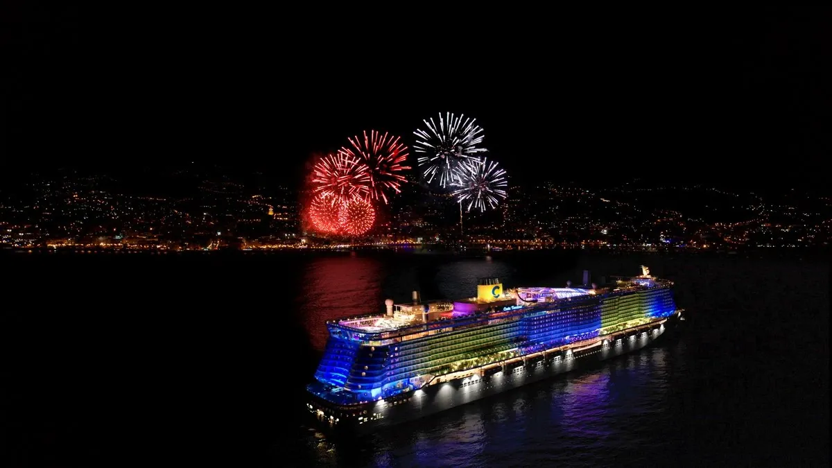 Costa Cruise Line ship aerial view at night with fireworks on th e background