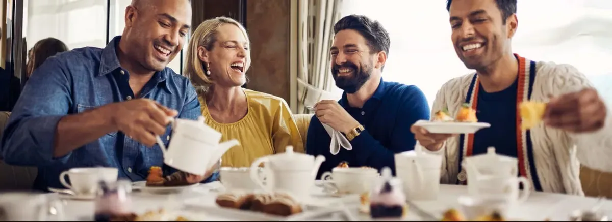 Group of people laughing while having breakfast