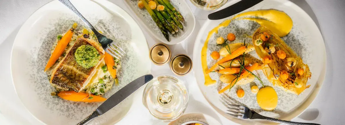 Detail of a table with plates with veggies and seafood