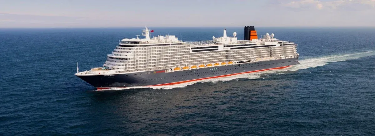 Aerial side view of a Cunar Cruise Line ship sailing in the ocean