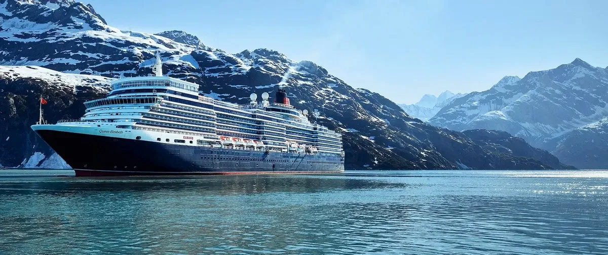Cruise ship sailing with alaskan mountains on the background