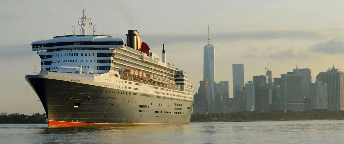 Cunard Cruise Line ship sailing with a city skyline in the background