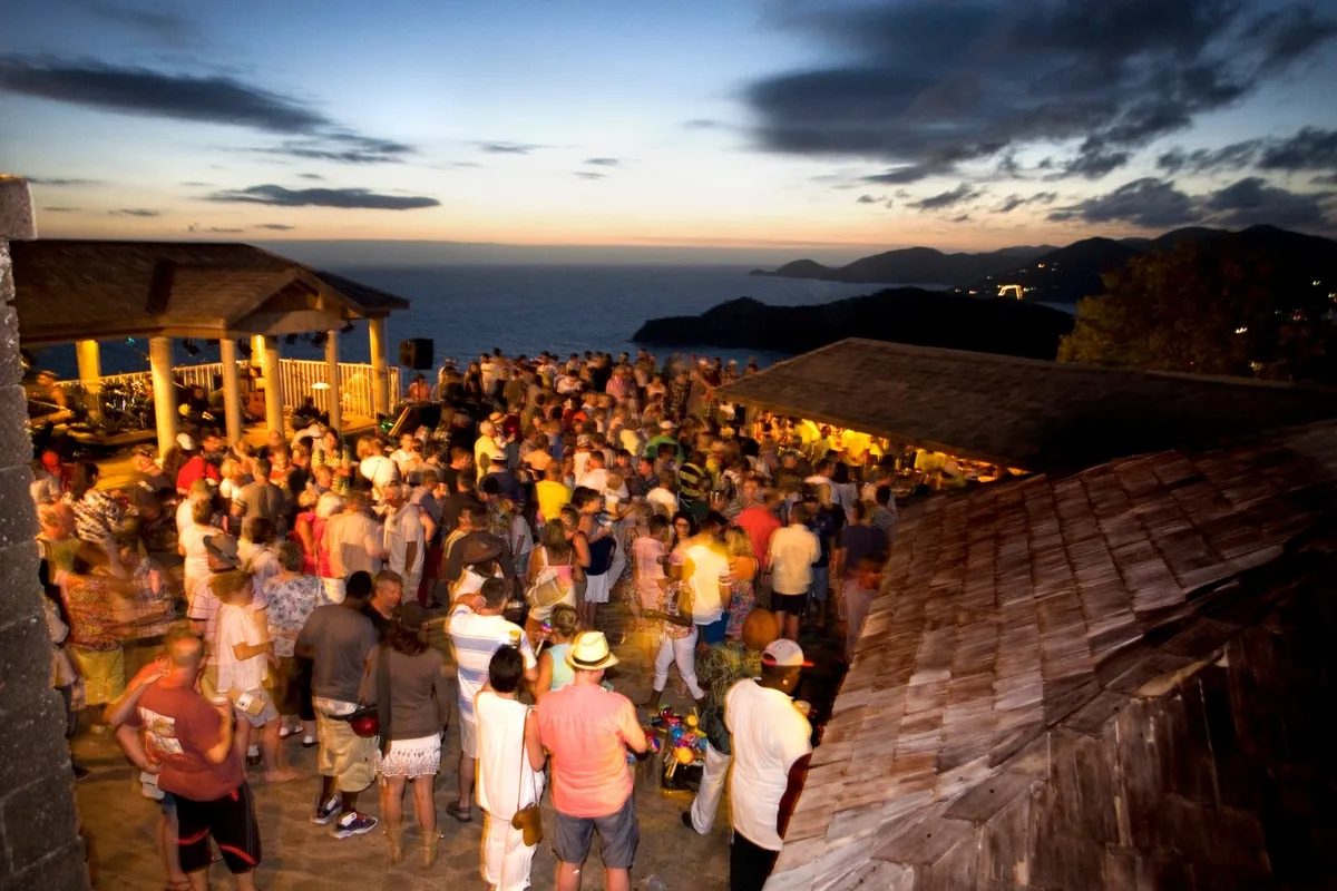 A large group of people having a party on the beach at twilight