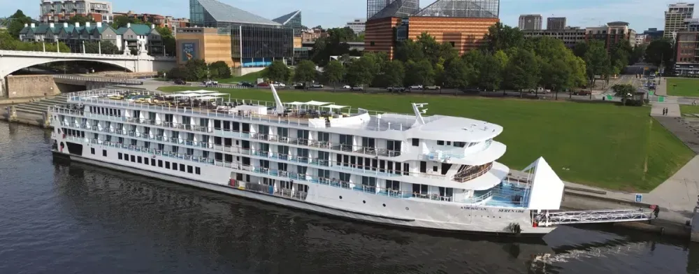 Cruise ship on a dock next to a city