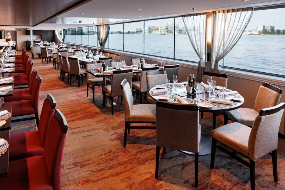 Dinning room inside of a cruise ship with a view to the river