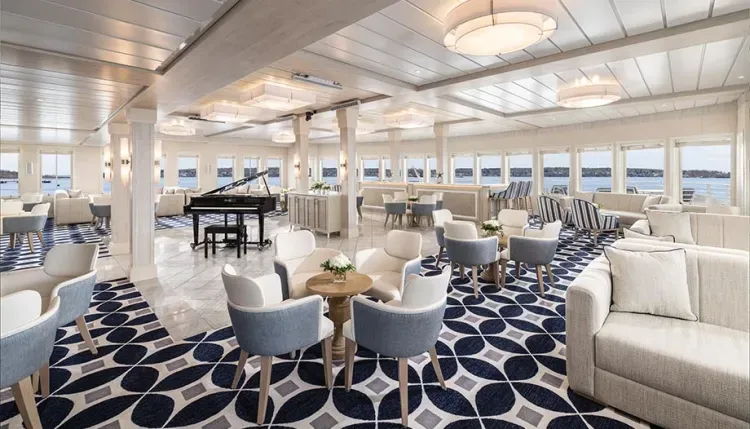 Cruise ship lounge room with many tables to hang out